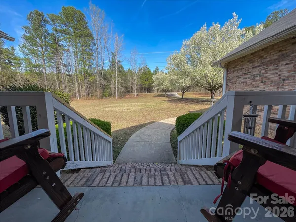 a view of balcony with wooden floor and outdoor seating