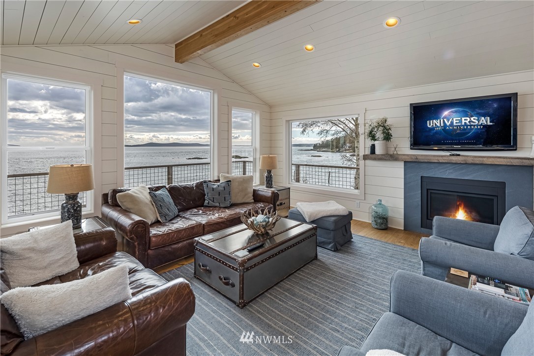 3051 Pear Point Road Friday Harbor, WA 98250 - Photo 13 of 39 a living room with furniture a flat screen tv and a fireplace