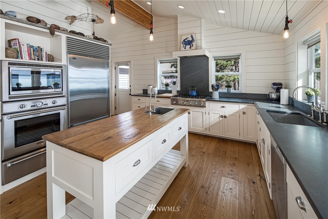 3051 Pear Point Road Friday Harbor, WA 98250 - Photo 14 of 39 a kitchen with a stove a sink and a refrigerator