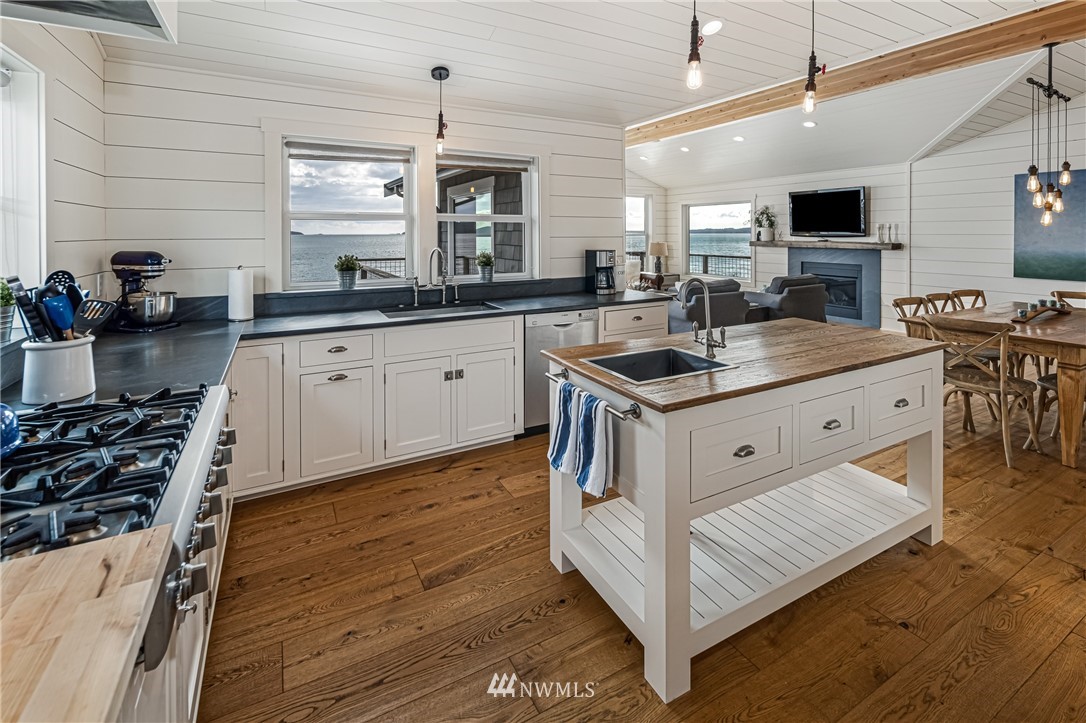 3051 Pear Point Road Friday Harbor, WA 98250 - Photo 16 of 39 a kitchen with stainless steel appliances granite countertop a stove oven and a sink with wooden floor