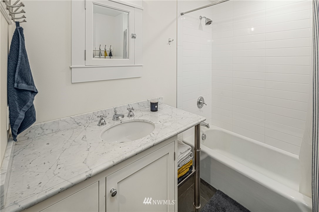 3051 Pear Point Road Friday Harbor, WA 98250 - Photo 22 of 39 a bathroom with a granite countertop sink and a bathtub