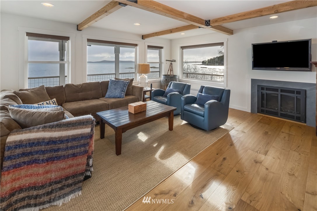 3051 Pear Point Road Friday Harbor, WA 98250 - Photo 26 of 39 a living room with furniture a flat screen tv and a fireplace