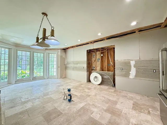 a view of a livingroom with wooden floor and a large window