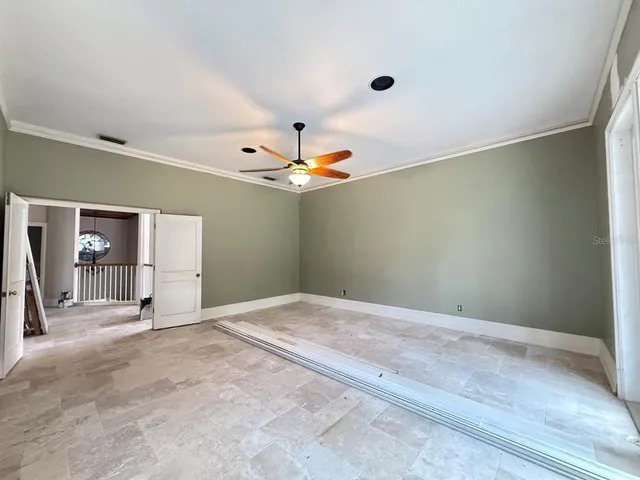 a view of an empty room with a ceiling fan