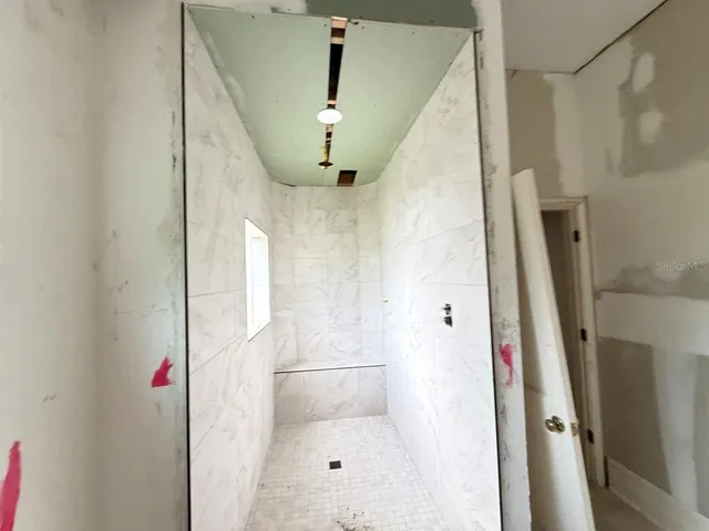 a bathroom with a shower and a sink