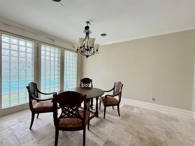 a dining room with furniture and window
