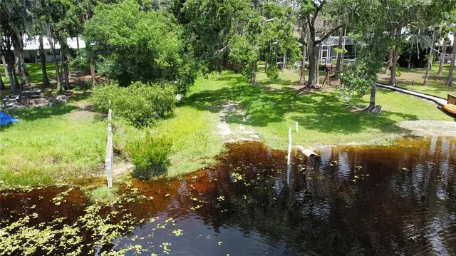 a backyard of a house with a yard and outdoor seating