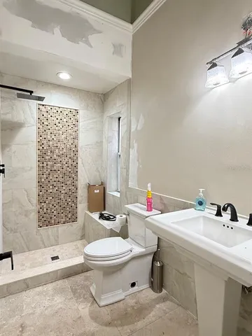 a bathroom with a sink toilet a shower and a mirror