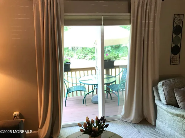 a view of a balcony with wooden floor and a potted plant