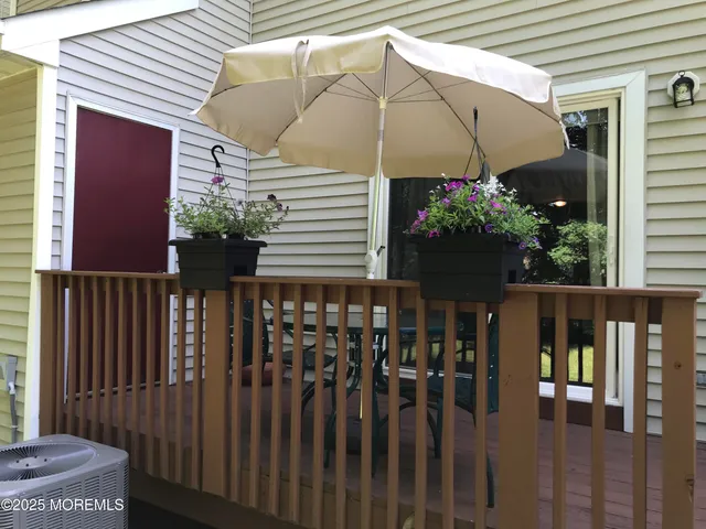 a couple of table and chairs under an umbrella