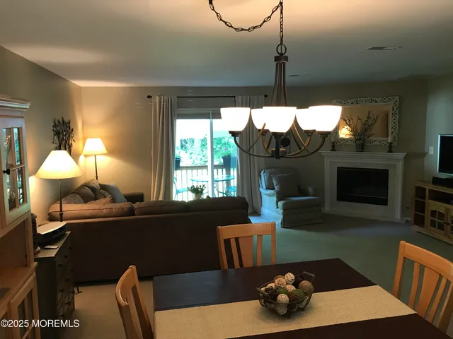 a living room with furniture a window and a fireplace