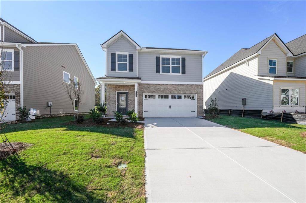 11827 Rizvan Place Covington, GA 30014 - Photo 1 of 1 a front view of a house with garden