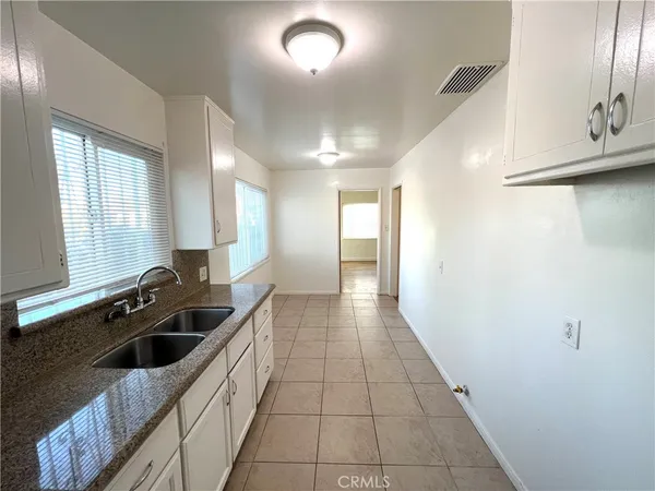 a kitchen with a sink and a refrigerator