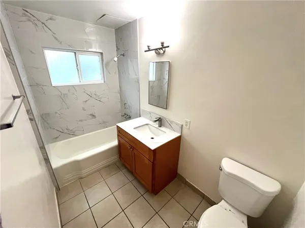a bathroom with a sink mirror vanity and toilet