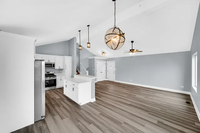 a view of kitchen with cabinets and wooden floor