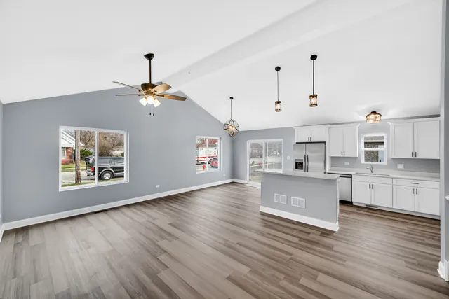 a view of kitchen and hall with wooden floor
