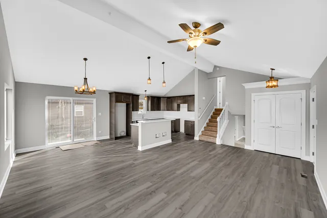a view of a kitchen with cabinets and wooden floor