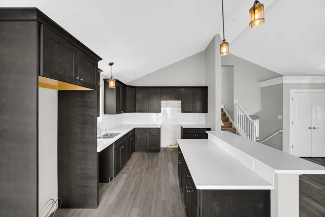 a kitchen with stainless steel appliances a sink and cabinets