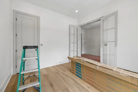 a view of an empty room with a fireplace and a window