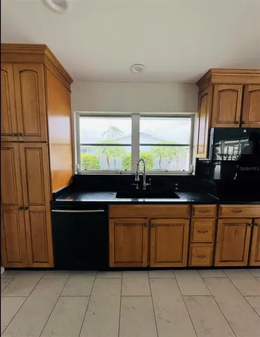 a kitchen with stainless steel appliances a sink and a microwave