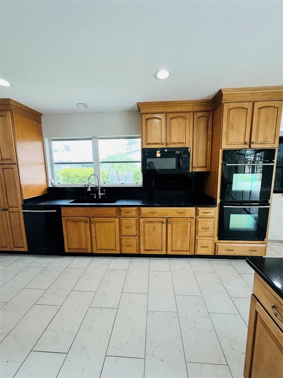 342 Severin Road Southeast Port Charlotte, FL 33952 - Photo 7 of 22 a kitchen with stainless steel appliances a sink and a microwave
