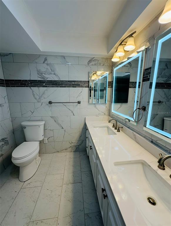 342 Severin Road Southeast Port Charlotte, FL 33952 - Photo 10 of 22 a bathroom with a sink double vanity and a toilet