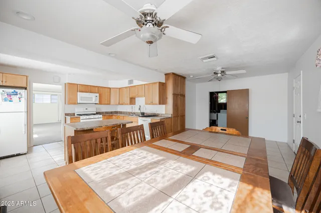 a large bedroom with kitchen island a sink stainless steel appliances and cabinets