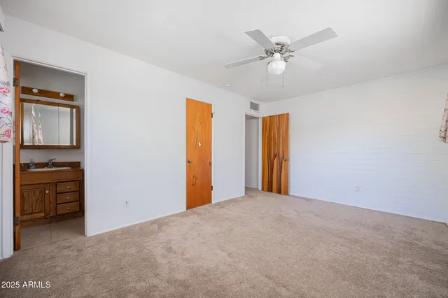 a view of an empty room with a ceiling fan
