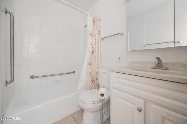 a bathroom with a granite countertop toilet a sink and a bathtub