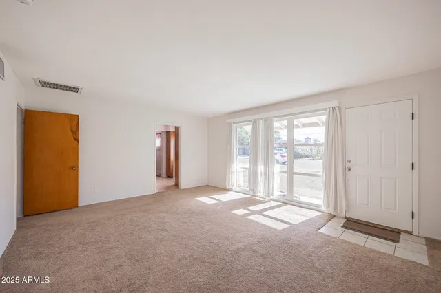 a view of an empty room with a window