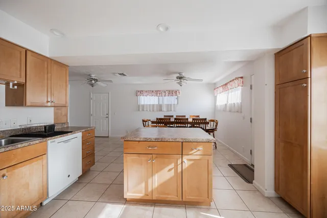 a kitchen with granite countertop a stove and a refrigerator