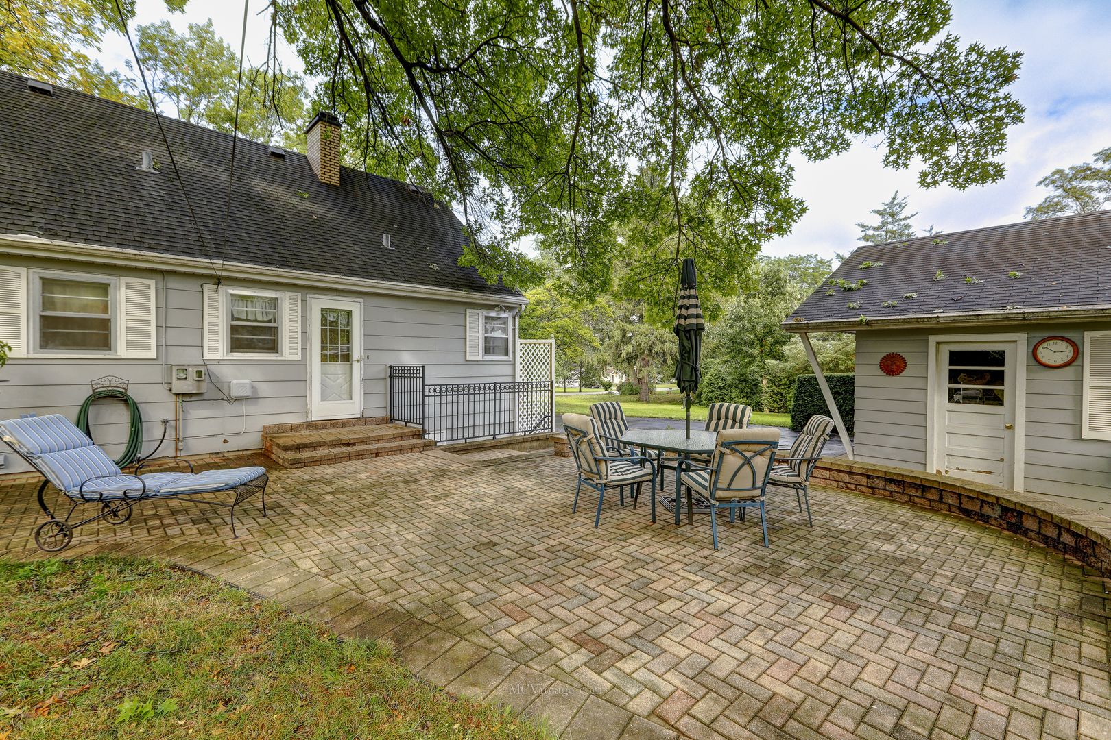 591 Riedy Road Lisle, IL 60532 - Photo 23 of 37 a view of a house with backyard sitting area and garden