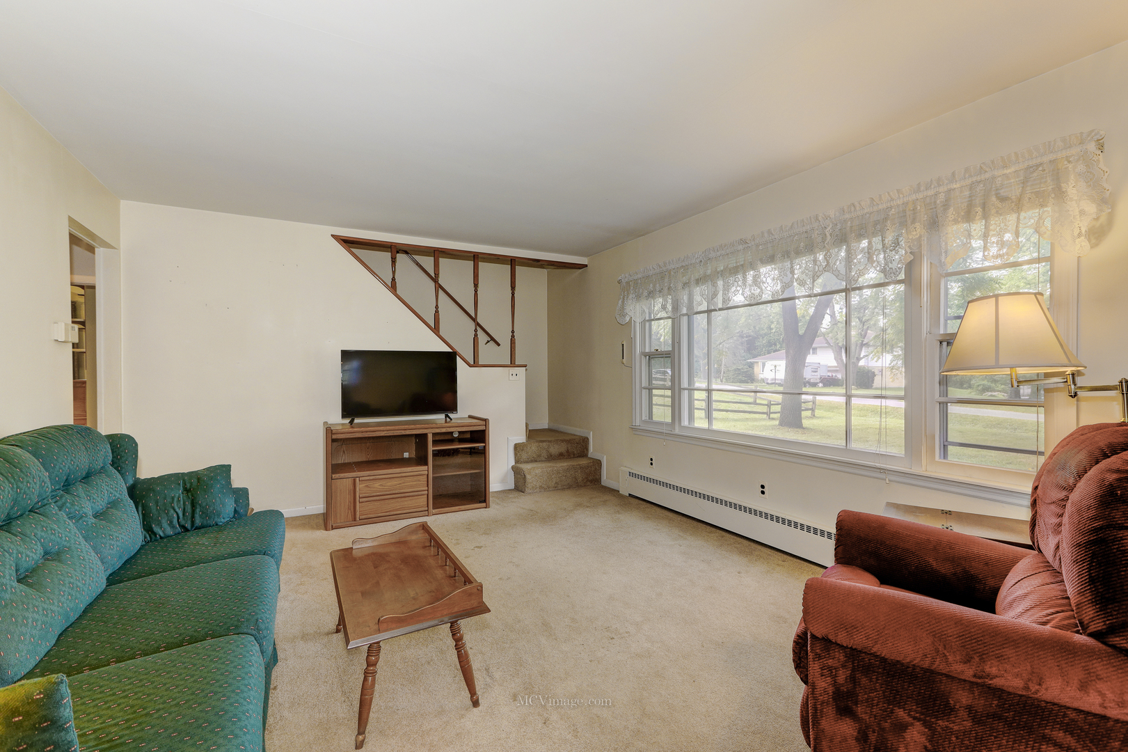 591 Riedy Road Lisle, IL 60532 - Photo 3 of 37 a living room with furniture and a flat screen tv