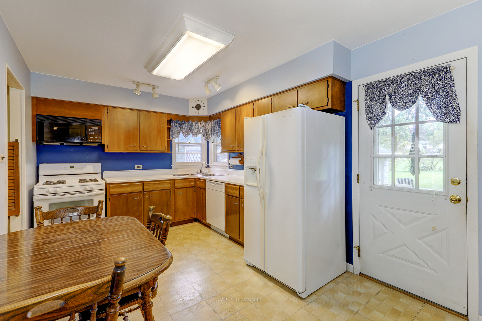591 Riedy Road Lisle, IL 60532 - Photo 8 of 37 a kitchen with a refrigerator a stove top oven a sink and cabinets