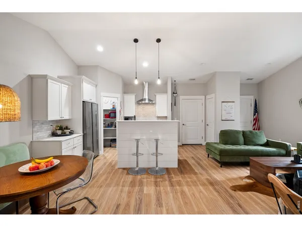 a living room with stainless steel appliances kitchen island granite countertop furniture and a view of kitchen