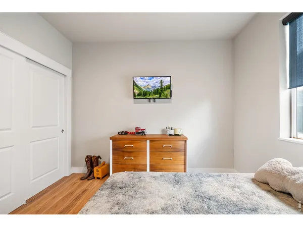 a bedroom with a bed and a dresser