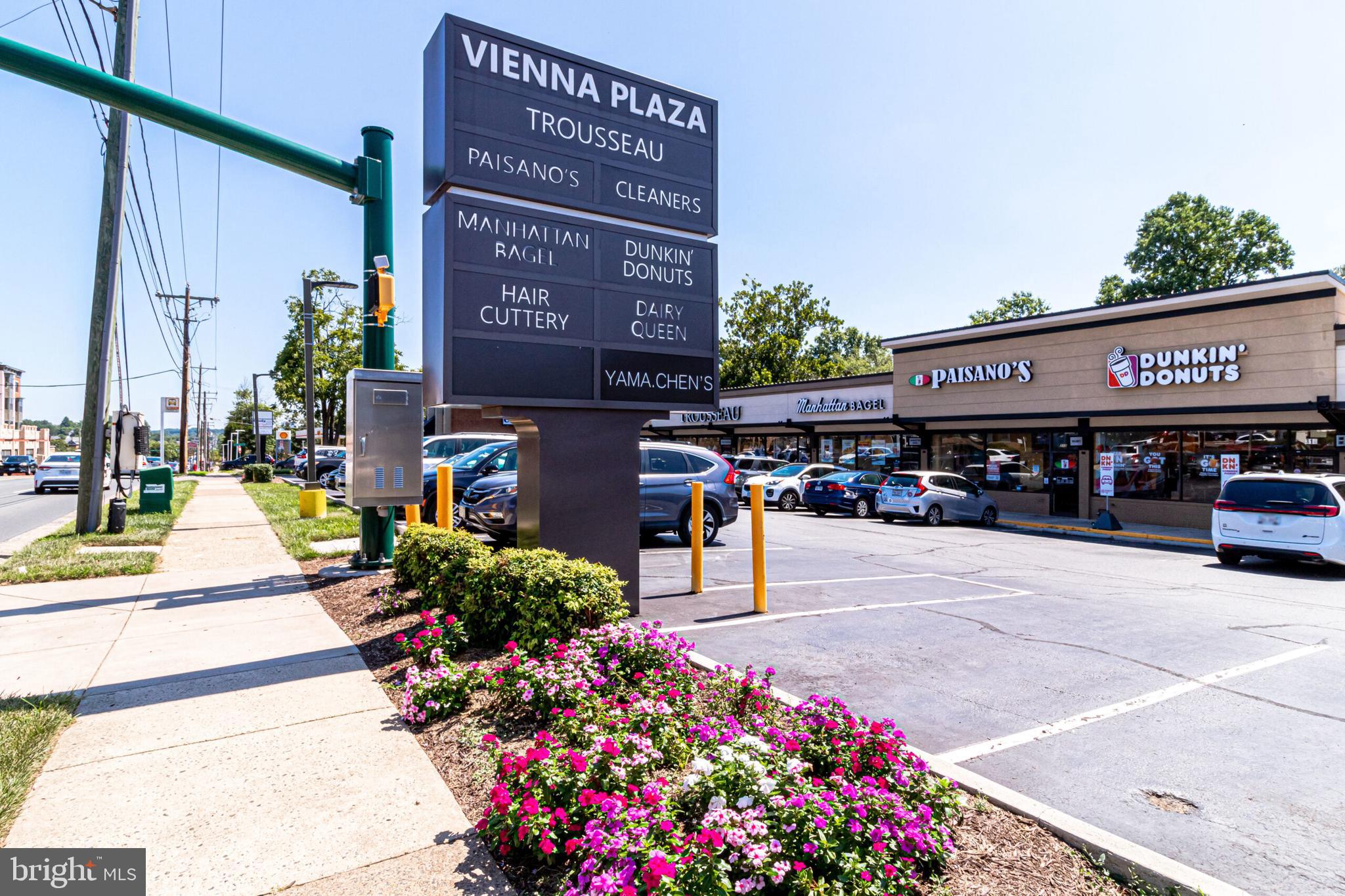 801 Meadow Lane Southwest Vienna, VA 22180 - Photo 22 of 24 a front view of multi story building with yard and bench