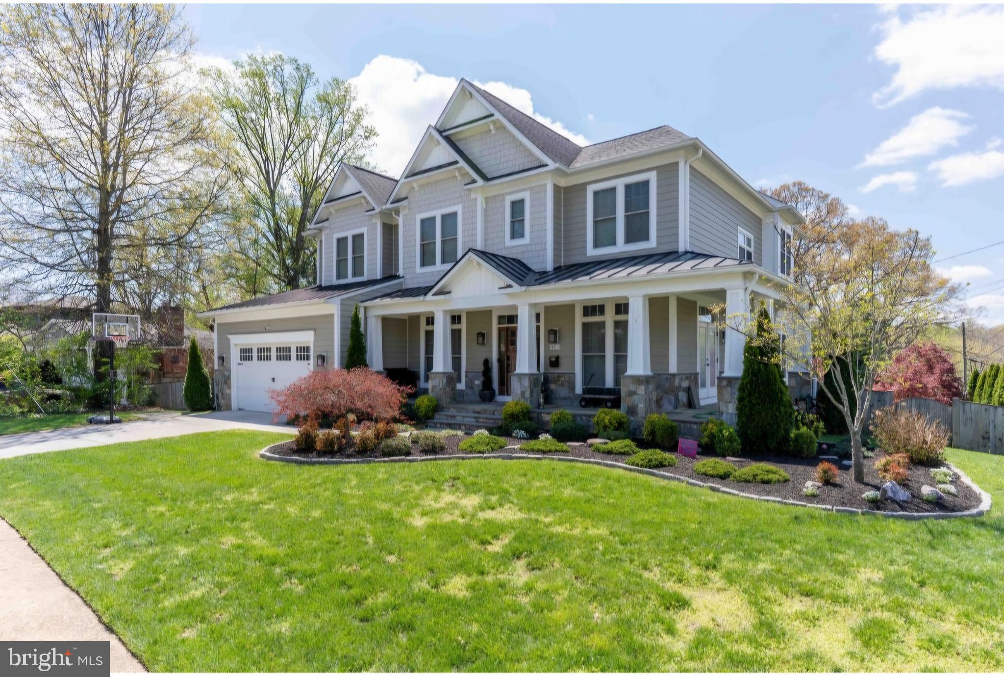 801 Meadow Lane Southwest Vienna, VA 22180 - Photo 4 of 24 a front view of a house with a yard and garage