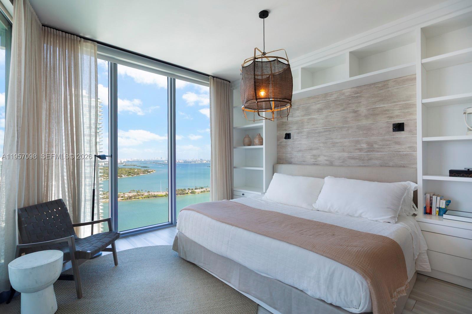 2900 Northeast 7th Avenue, Unit 3701 Miami, FL 33137 - Photo 11 of 23 a spacious bedroom with a bed and a chandelier