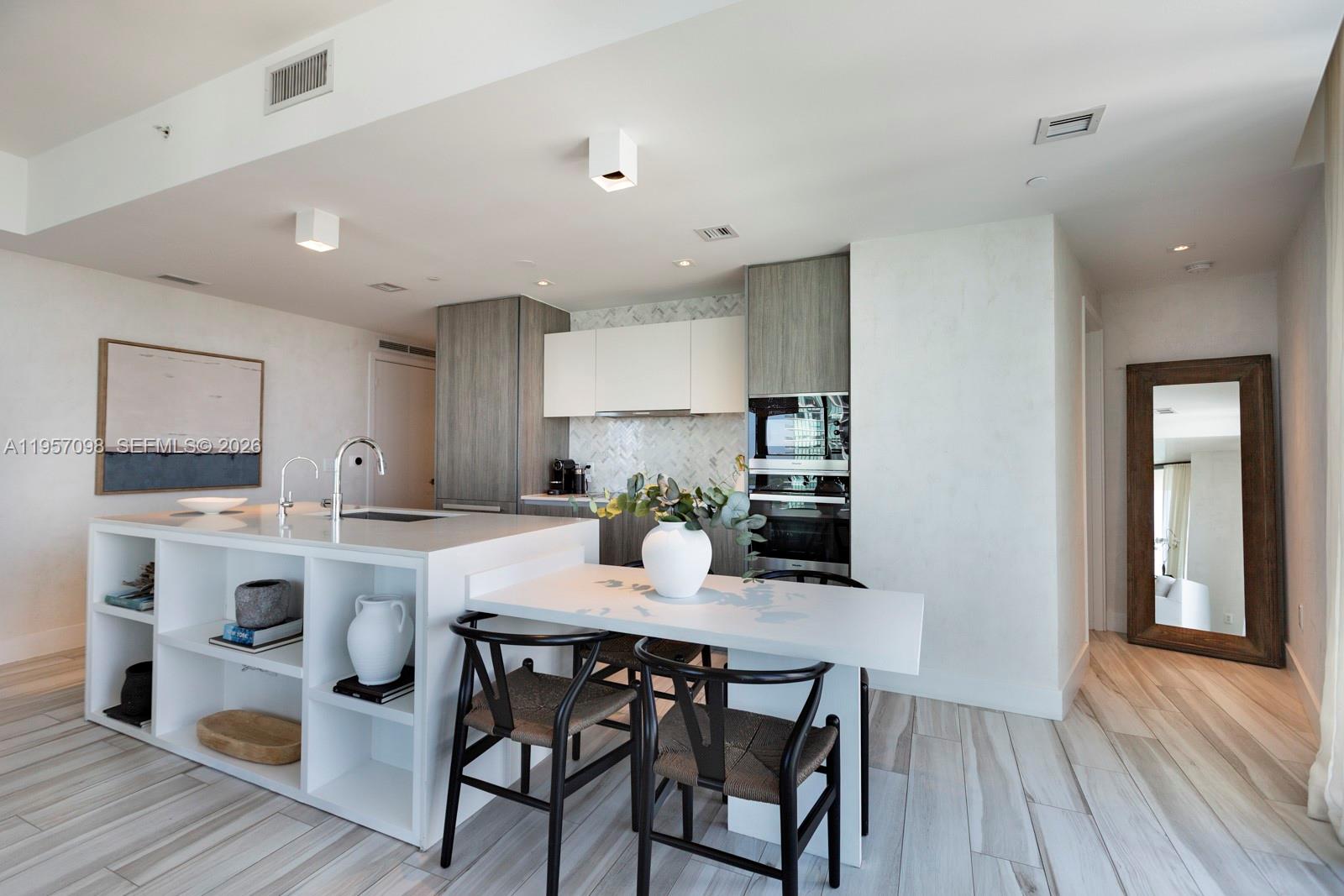 2900 Northeast 7th Avenue, Unit 3701 Miami, FL 33137 - Photo 8 of 23 a kitchen with a dining table chairs and wooden floor