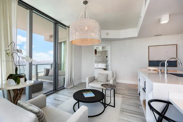 a living room with furniture a rug and white walls
