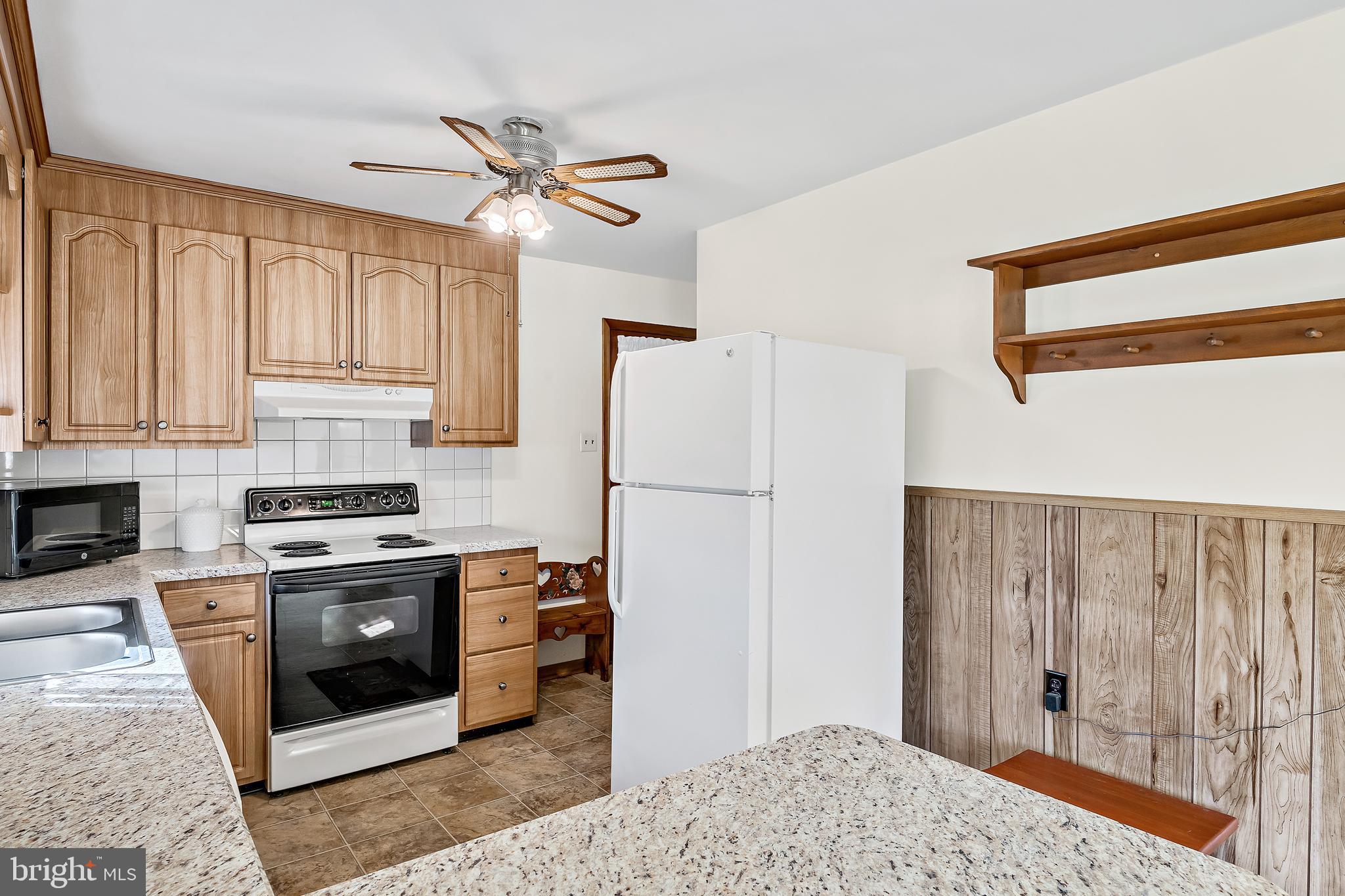 1280 Kunkle's Mill Road Wellsville, PA 17365 - Photo 11 of 40 a kitchen with stainless steel appliances granite countertop a refrigerator sink and stove