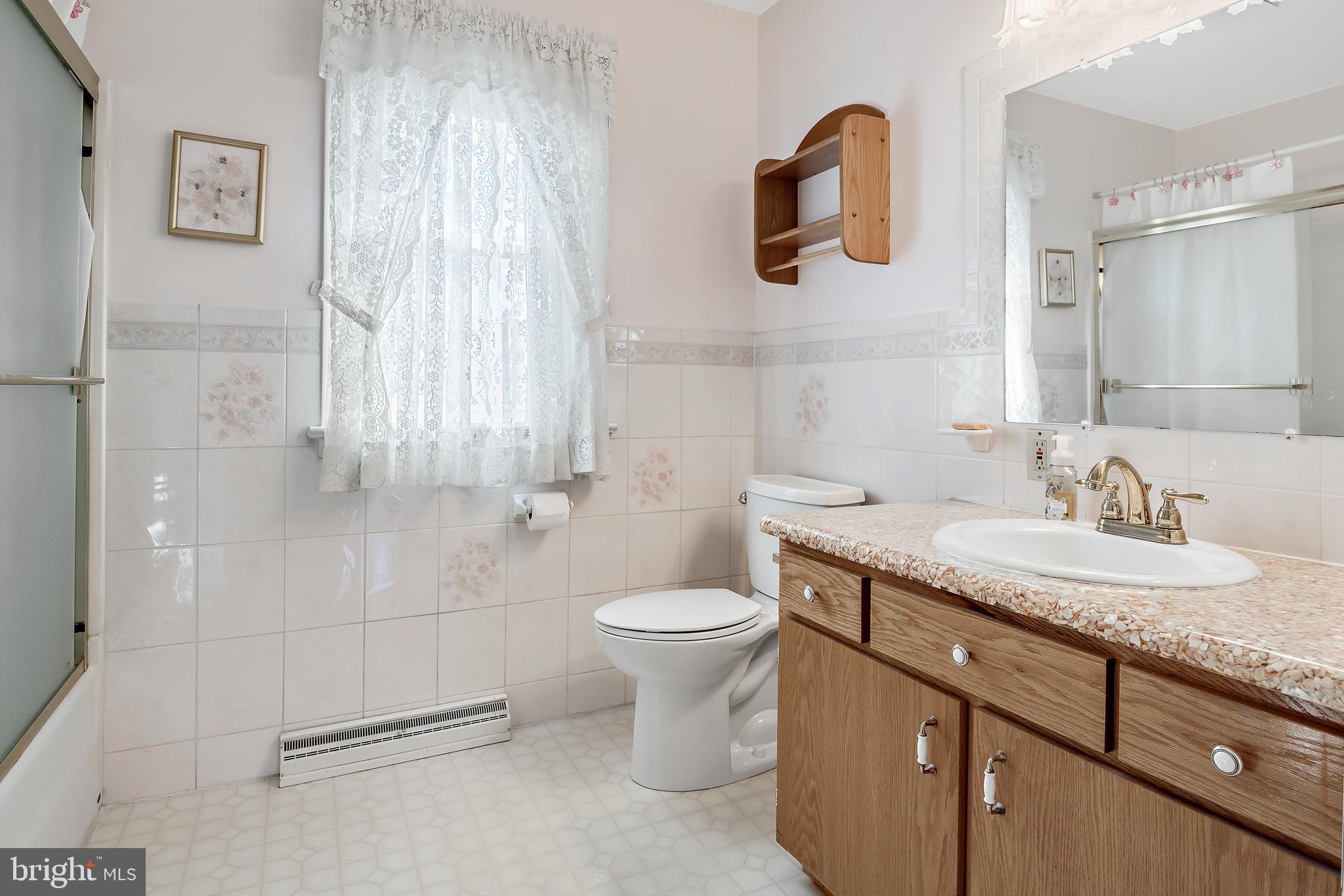 1280 Kunkle's Mill Road Wellsville, PA 17365 - Photo 19 of 40 a bathroom with a granite countertop toilet sink and mirror
