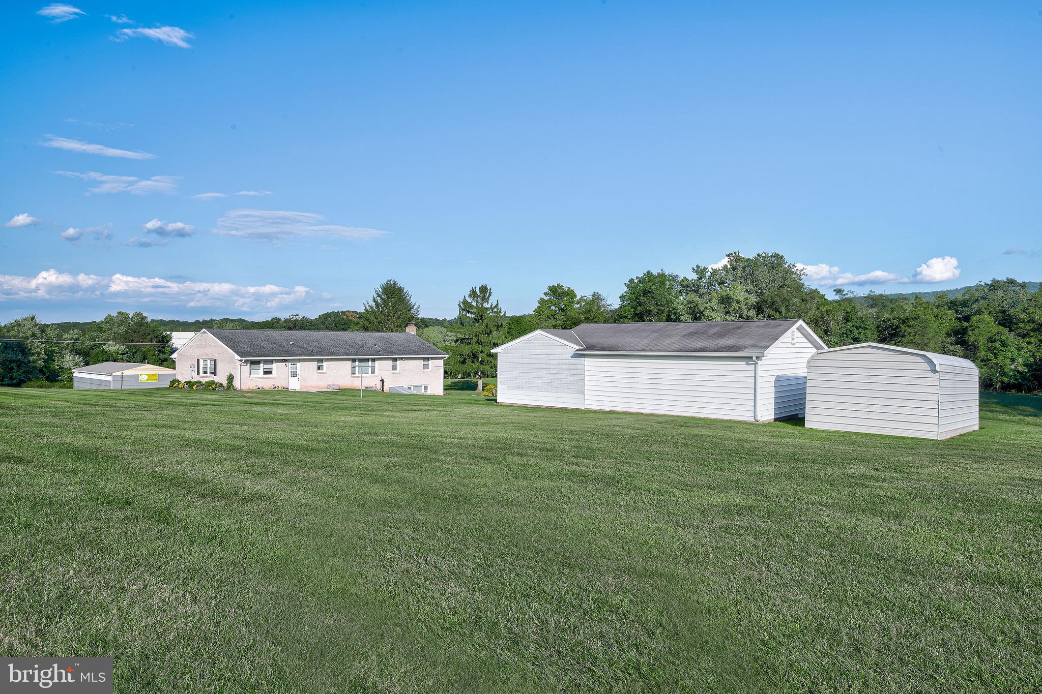 1280 Kunkle's Mill Road Wellsville, PA 17365 - Photo 33 of 40 a front view of a house with a garden and yard