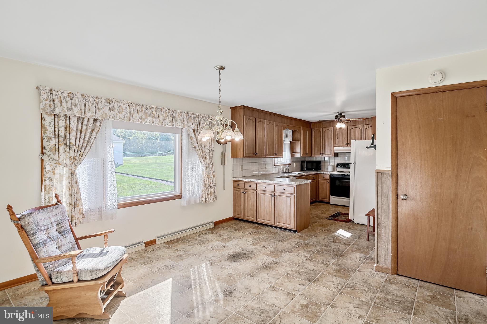 1280 Kunkle's Mill Road Wellsville, PA 17365 - Photo 6 of 40 a kitchen with stainless steel appliances a refrigerator sink and cabinets