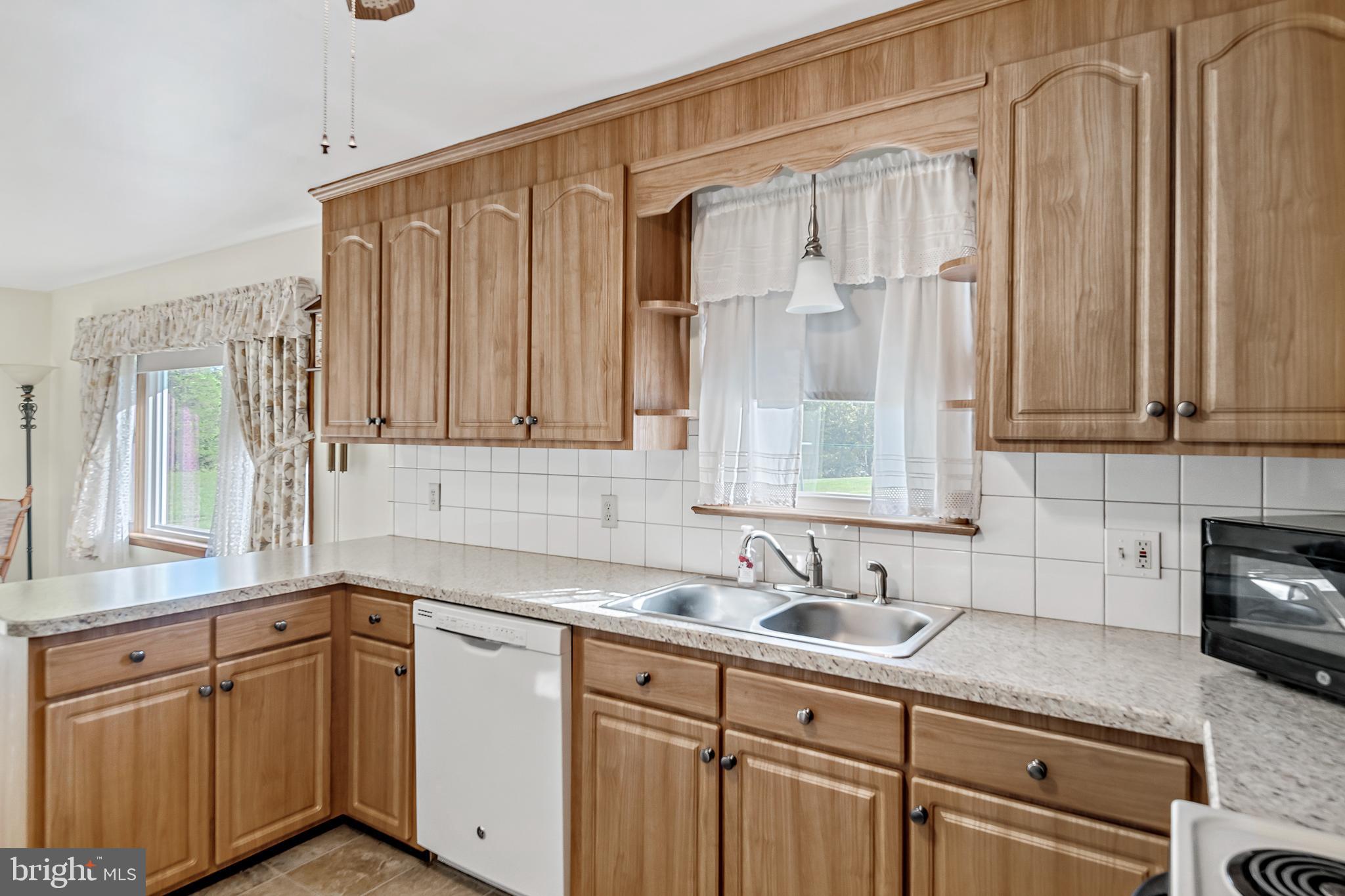 1280 Kunkle's Mill Road Wellsville, PA 17365 - Photo 9 of 40 a kitchen with stainless steel appliances granite countertop white cabinets a sink and dishwasher