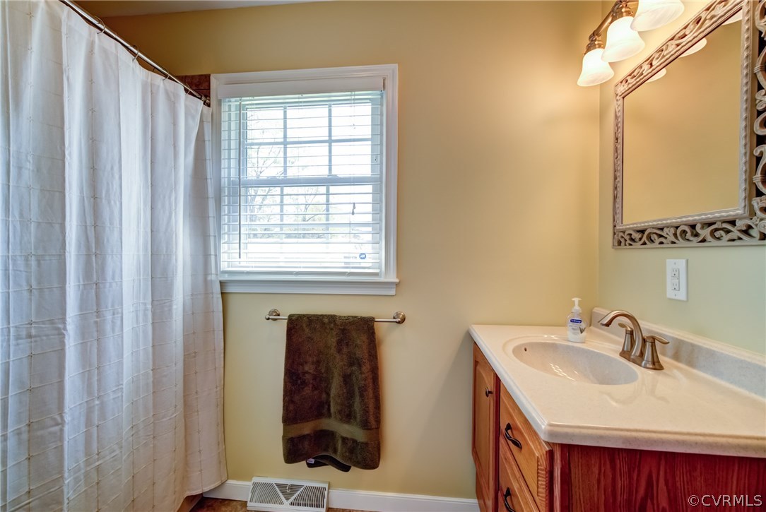 301 Meadowville Road Chester, VA 23836 - Photo 20 of 25 a bathroom with a sink and a mirror