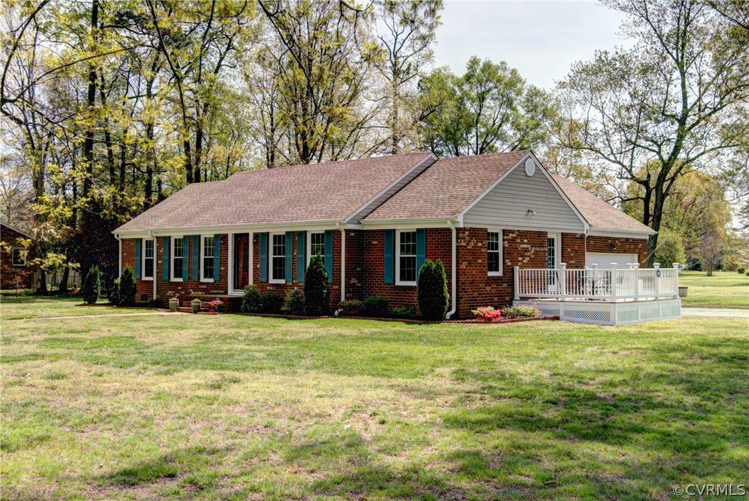301 Meadowville Road Chester, VA 23836 - Photo 2 of 25 a front view of a house with a garden and trees