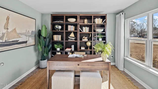 a view of a dining room with furniture and a potted plant