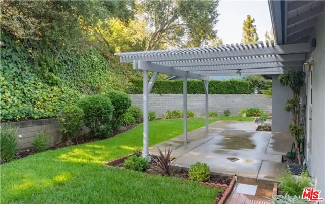 a view of a house with a yard patio and a garden